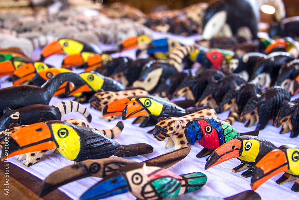 Fototapeta premium Argentina, Iguazu, June 07, 2019: Sale of souvenirs at the waterfalls. Toucans, animals, coatis planed from wood figures. Selective focus