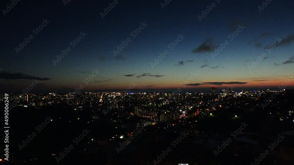 NAHA, OKINAWA, JAPAN - AUG 2021 : Aerial sunrise view of Naha city. Cityscape of downtown area. High angle wide view, time lapse shot night to morning. Summer holiday, vacation and travel concept. NAHA, OKINAWA, JAPAN - AUG 2021 : Aerial sunrise view of Naha city. Cityscape of downtown area. High angle wide view, time lapse shot night to morning. Summer holiday, vacation and travel concept.