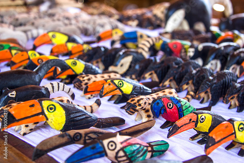 Argentina, Iguazu, June 07, 2019: Sale of souvenirs at the waterfalls. Toucans, animals, coatis planed from wood figures. Selective focus