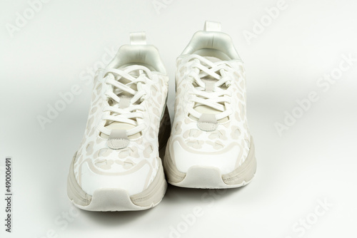 Pair of trendy sneakers on a white background. Close-up