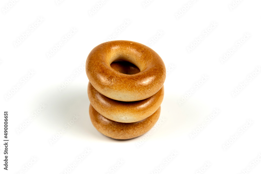 Drying or mini round bagels in the shape of a tower on a white background. Copy, empty space for text