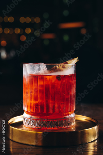 Classic old fashioned Cocktail in a retro glass with ice and pineapple slice