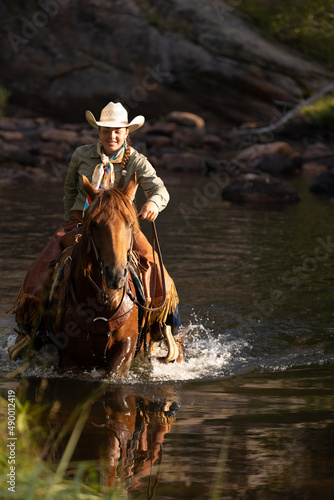 Cowgirl Crossing Water on a Quarter Horse