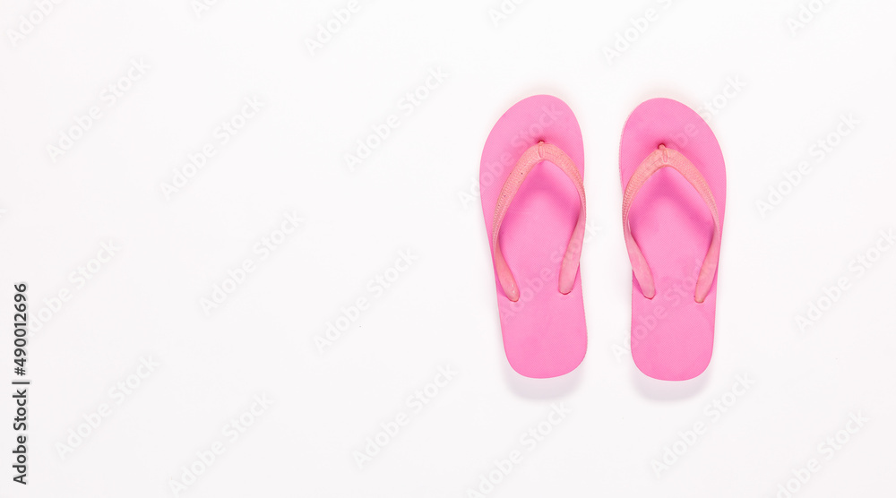 Closeup top view studio isolated shot pair of fashionable beautiful bright pink casual comfortable unisex rubber material slipper, flip flop, sandal, footwear on white background with copy space. Closeup top view studio isolated shot pair of fashionable beautiful bright pink casual comfortable unisex rubber material slipper, flip flop, sandal, footwear on white background with copy space.