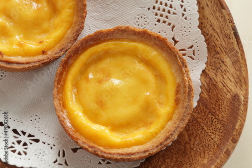 Asian sweet dessert, egg tart on wooden plate with copy space