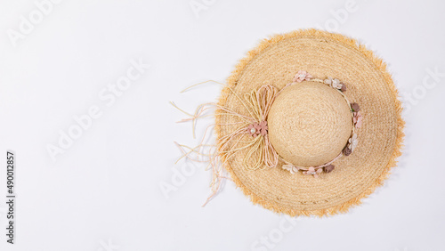Closeup studio top view isolated shot of beautiful fashionable Asian modern classic style lady woman wicker woven weaving rattan handmade handicraft hat with dry flowers hatband on white background