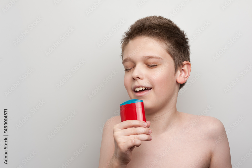 the boy enjoys the pleasant aroma of deodorant the boy enjoys the pleasant aroma of deodorant