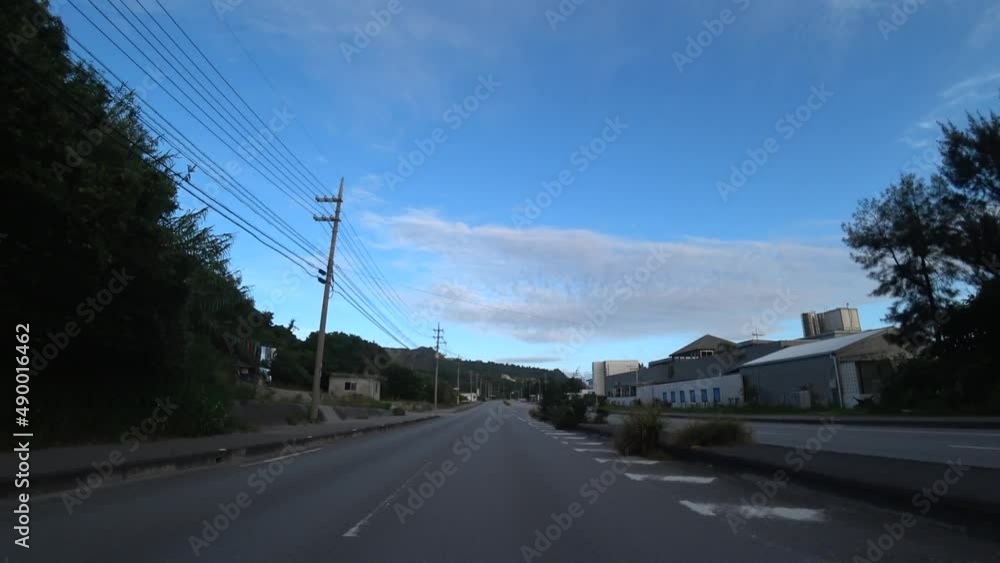 OKINAWA, JAPAN - AUGUST 2021 : Driving shot of Okinawa in sunset time. Point of view (POV), seaside road drive, time lapse shot. Summer holiday, vacation and travel concept video. OKINAWA, JAPAN - AUGUST 2021 : Driving shot of Okinawa in sunset time. Point of view (POV), seaside road drive, time lapse shot. Summer holiday, vacation and travel concept video.