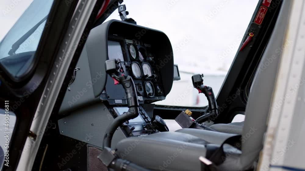 view of pilot cabin and stick joystick of civilian business helicopter, cockpit is inside. Aircraft instrument panel, focus on helicopter control stick. view of pilot cabin and stick joystick of civilian business helicopter, cockpit is inside. Aircraft instrument panel, focus on helicopter control stick.