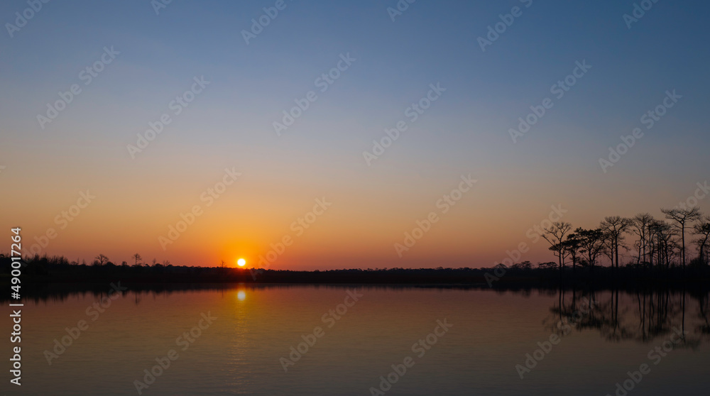 sunrise at coast of the lake. Blue sky and sun reflection on water. Nature landscape in asian. sunrise at coast of the lake. Blue sky and sun reflection on water. Nature landscape in asian.