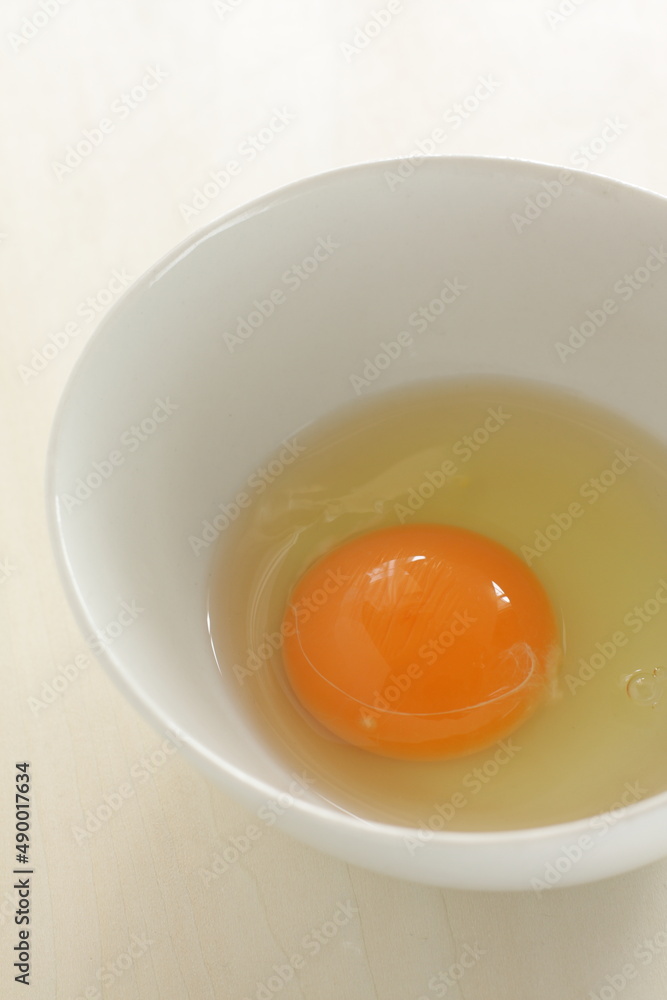 raw egg in white bowl with copy space raw egg in white bowl with copy space