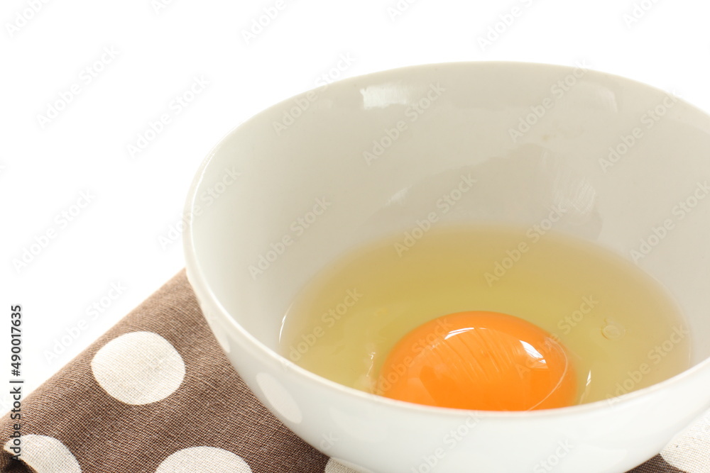 raw egg in white bowl with copy space raw egg in white bowl with copy space