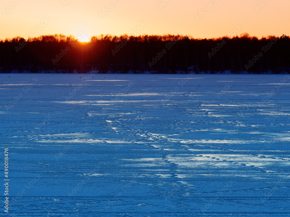 Dramatic sunset on winter river background