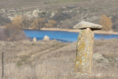 Acient stone pillar on the slopes of the river Ingul, in Ukraine. Rocks of the Mesozoic geological era. Landscape of steppe slopes. photo
