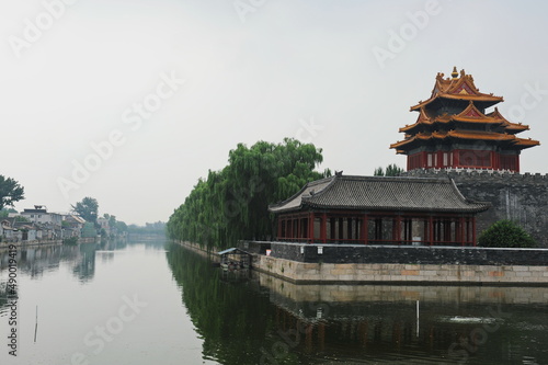 Beijing / China - 08.06.2012 : Gazebo in the old traditional style in the forbidden city. View from the river with reflection.