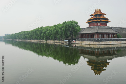 Beijing / China - 08.06.2012 : Gazebo in the old traditional style in the forbidden city. View from the river with reflection.