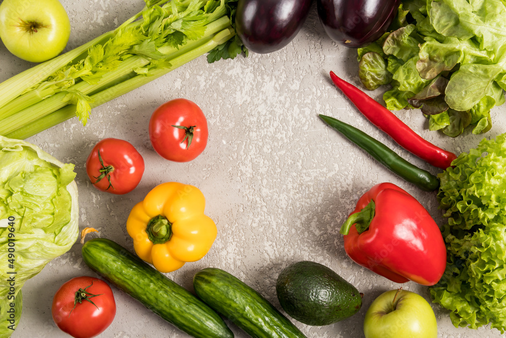 a frame of fresh vegetables on a gray concrete background with space for text. organic, natural, healthy food. flat layout. a frame of fresh vegetables on a gray concrete background with space for text. organic, natural, healthy food. flat layout.