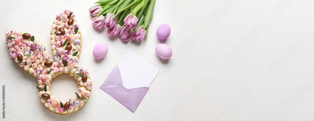 Beautiful cake and empty greeting card for Easter celebration on light background with space for text Beautiful cake and empty greeting card for Easter celebration on light background with space for text