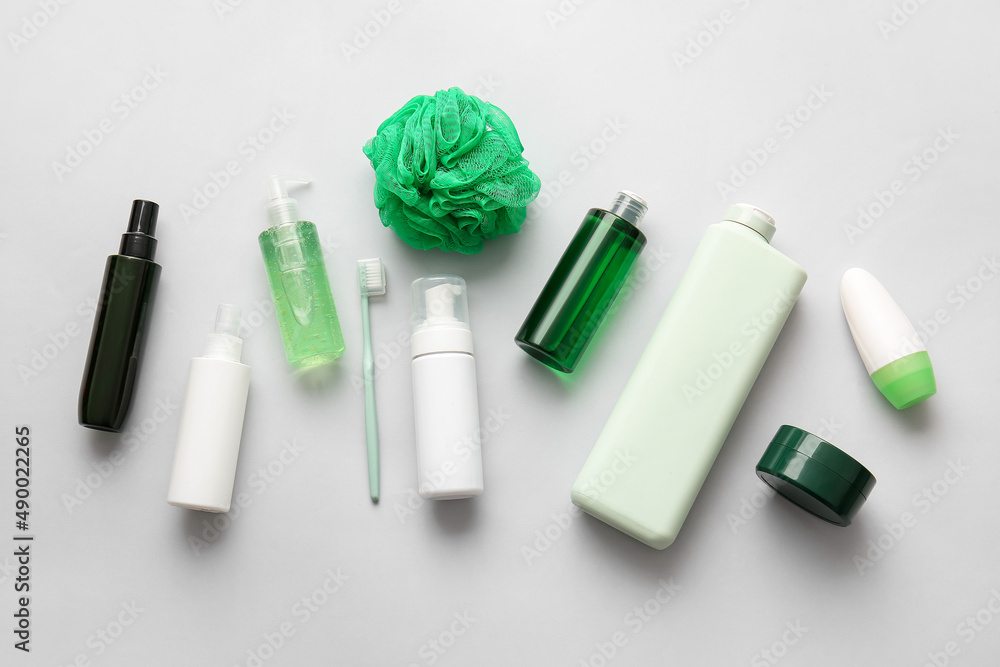 Set of cosmetic products, toothbrush and bath sponge on white background Set of cosmetic products, toothbrush and bath sponge on white background
