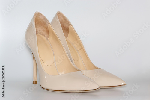 Front view of the nude colored high heeled women's shoes.