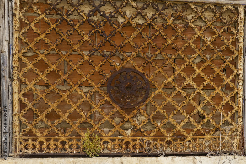 cast iron decoration above an entrance door to an old house in Portimao, Algarve, Portugal