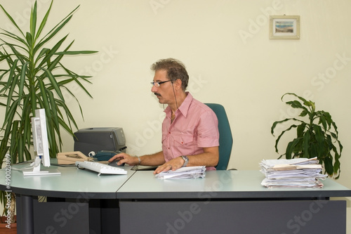 Man working on the computer in his office. photo