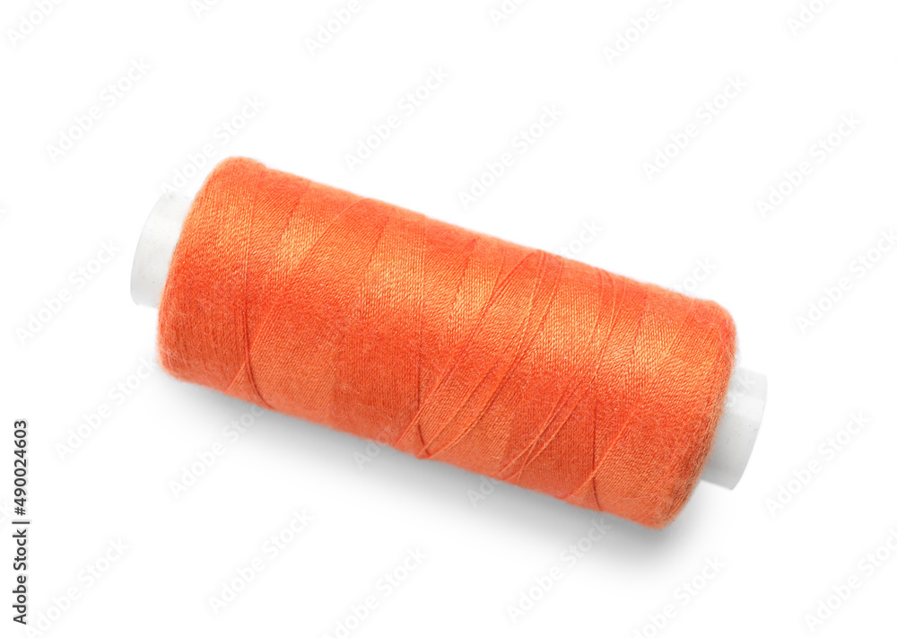 Orange sewing thread spool on white background Orange sewing thread spool on white background