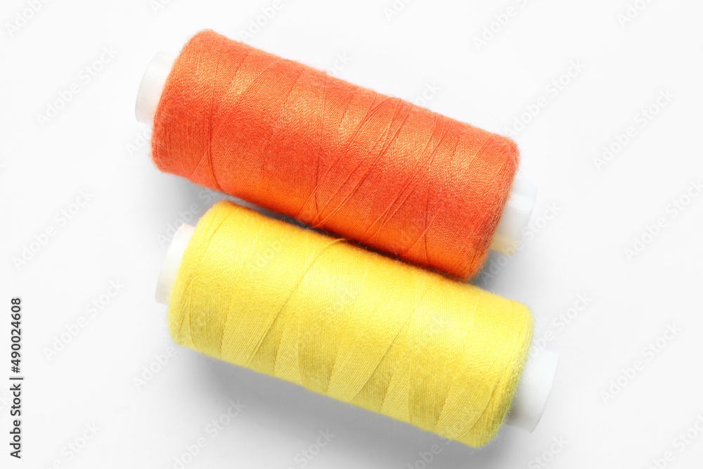 Beautiful sewing threads on white background Beautiful sewing threads on white background