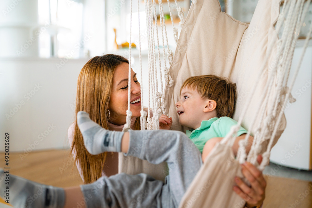 Happy mother with child playing and hugging at home. Happiness, parenting, childhood concept. Happy mother with child playing and hugging at home. Happiness, parenting, childhood concept.
