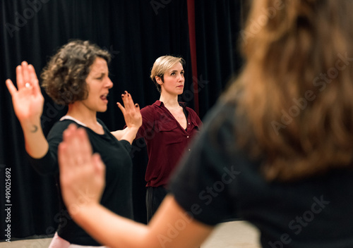 theater students during exercise with emphasis on arms showing different reactions