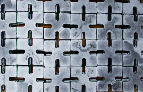 Close-up of galvanized metal plates for securing cargo on the deck of a cargo ship.