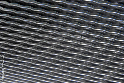 shiny metallic waves of bent metal. aluminum stamping in production