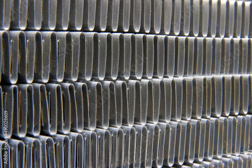 shiny metallic waves of bent metal. aluminum stamping in production