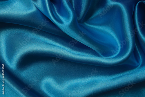 Dark blue fabric texture background, detail of silk or linen pattern.