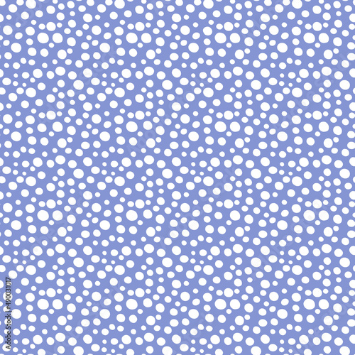 Abstract vector seamless repeat pattern with irregular white ditsy dots on a trendy very peri purple background