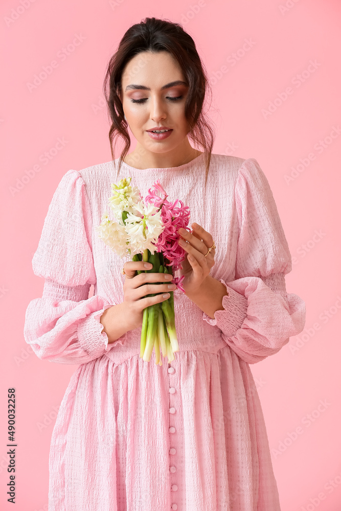 Pretty young woman with hyacinth flowers on pink background Pretty young woman with hyacinth flowers on pink background