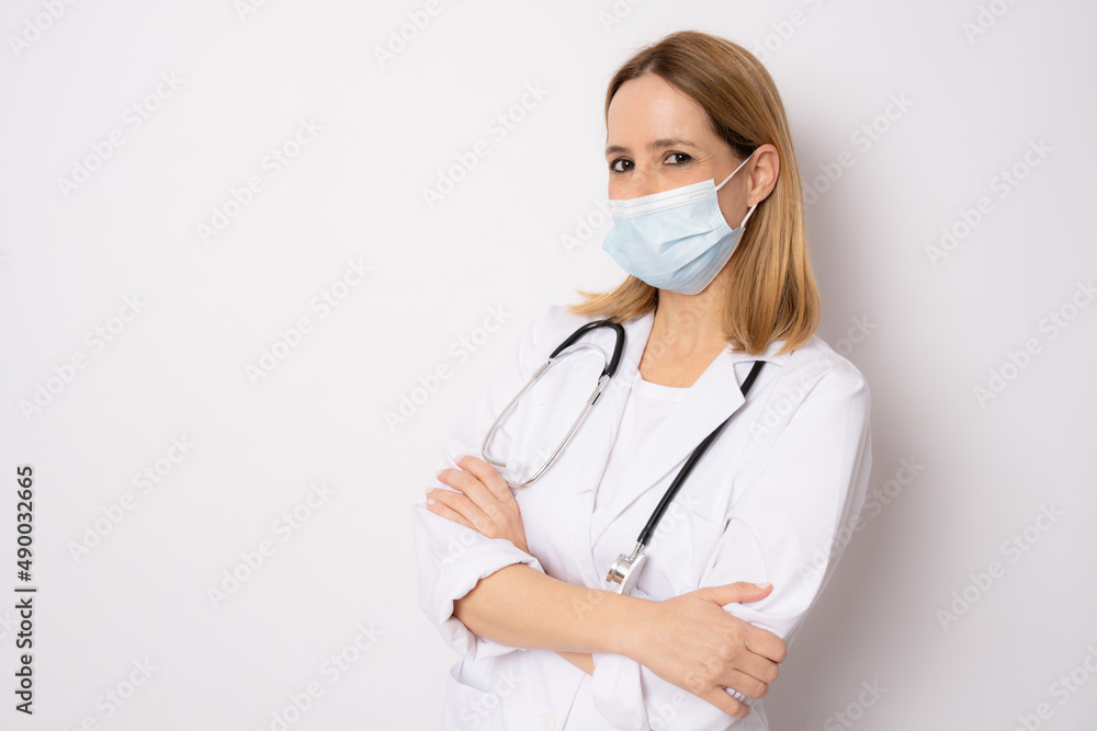 Confident woman doctor wearing medical mask standing with crossed arms. isolated female portrait. Confident woman doctor wearing medical mask standing with crossed arms. isolated female portrait.