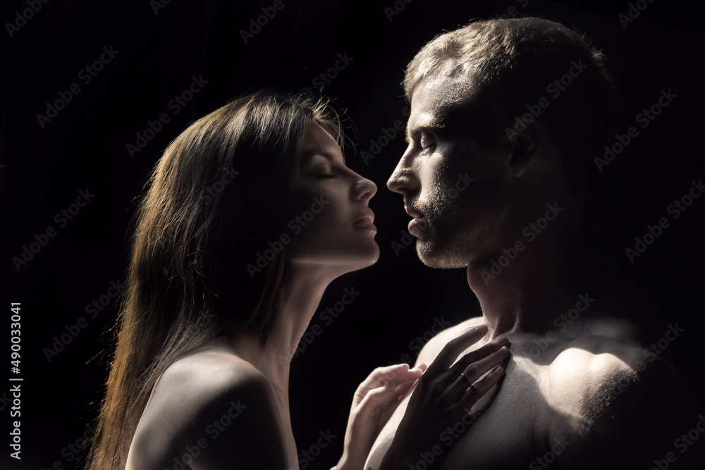 Portrait of lovely couple in love. Young sensual girlfriend glad to passionate kiss from her boyfriend. Handsome man embraces his woman and kisses. Portrait of lovely couple in love. Young sensual girlfriend glad to passionate kiss from her boyfriend. Handsome man embraces his woman and kisses.
