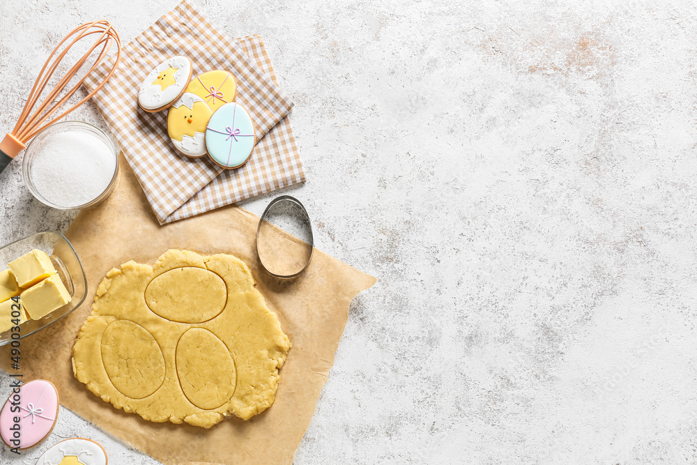 Fresh dough and tasty Easter cookies on light background Fresh dough and tasty Easter cookies on light background