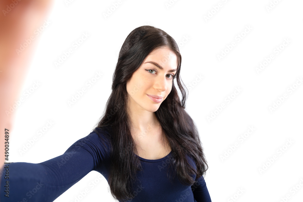 Beautiful woman taking a selfie. Isolated on white background. 19-20 years old caucasian woman. Beautiful woman taking a selfie. Isolated on white background. 19-20 years old caucasian woman.
