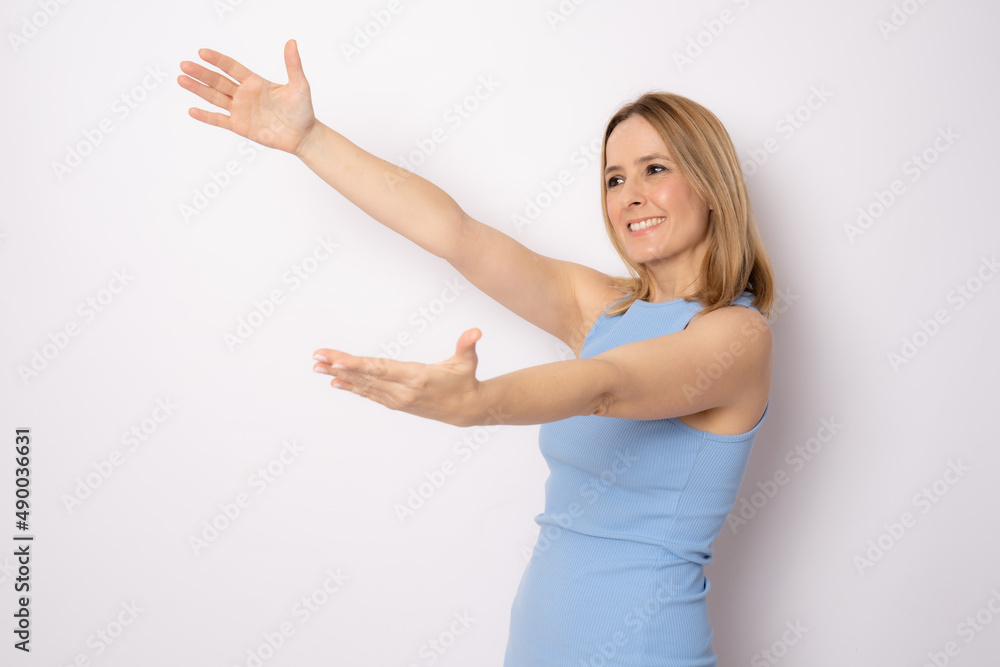 Young beautiful woman smiling cheerfully giving a warm, friendly, loving welcome hug, feeling happy and adorable Young beautiful woman smiling cheerfully giving a warm, friendly, loving welcome hug, feeling happy and adorable