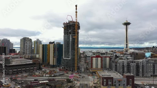 Aerial of a skyscraper being constructed near the Seattle Space Needle.
