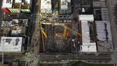 Overhead aerial of construction cranes at the beginning of a downtown build.