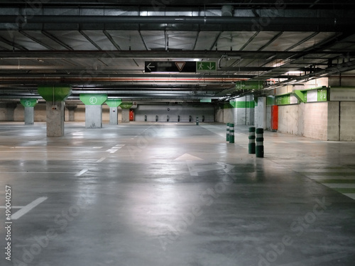 Empty car parking with columns and signs on the floor