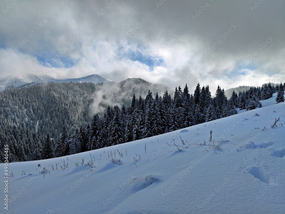 Winter in the mountains. Hiking during wintertime. Snow storm in the high mountains Winter in the mountains. Hiking during wintertime. Snow storm in the high mountains