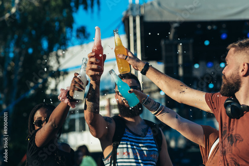 Group of friends drinking cocktails and having fun at music festival