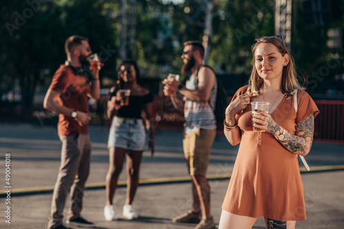 Group of friends drinking beer while having fun at music festival