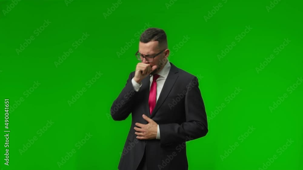Businessman in white shirt and tie suffering sore throat and coughing over isolated green background Businessman in white shirt and tie suffering sore throat and coughing over isolated green background