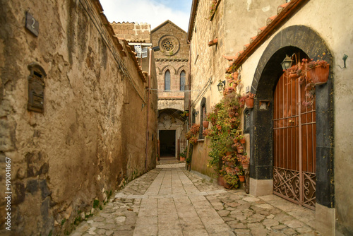 Fototapeta Naklejka Na Ścianę i Meble -  A narrow street among the old stone houses of the oldest district of the city of Caserta Vecchia, Italy.