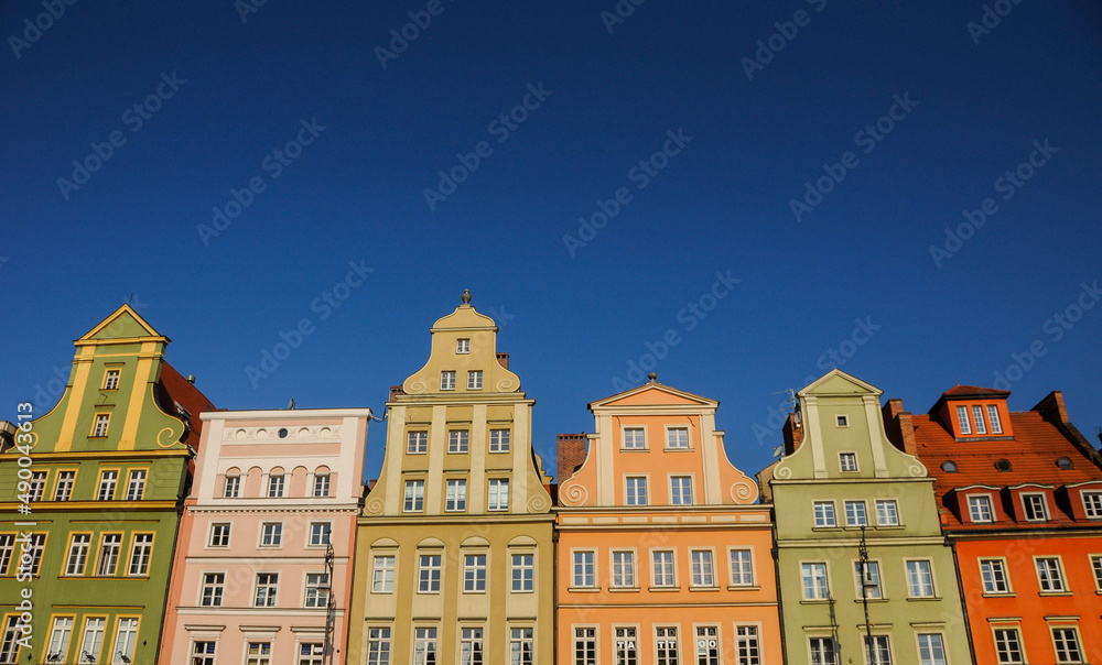Fototapeta premium Roofs of Wroclaw central market square (Rynek) in Wroclaw old historic town with old colorful buildings. Famous touristic destination. Beautiful architecture. Space for text.